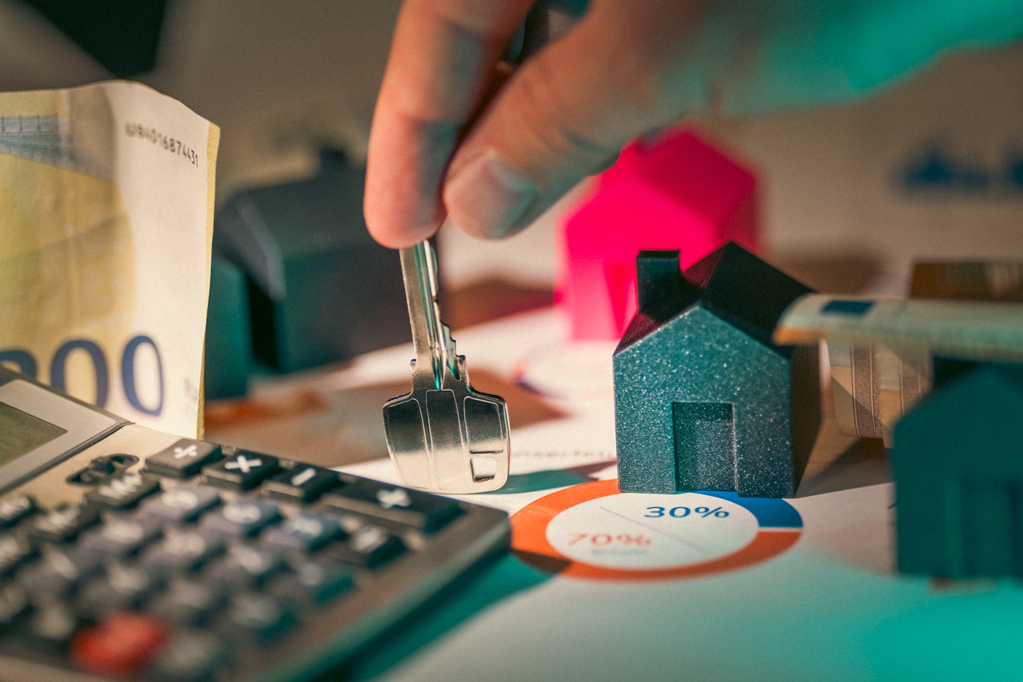 Housing investment financing prices. Hand holding key to new house door .